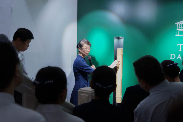 Beside the stairway at the entrance is a large bamboo coin bank which accepts donations for Tzu Chi’s charity fund from visitors. (Photo by Nichelle Chan)